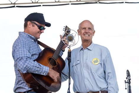 Arthur Hancock, right, smiles while his son, Arthur IV, plays guitar during a rendition of the song ‘Sunday Silence,’ during the dedication of a mural honoring the horse, Sunday Silence, at the Hotel Thoroughbred in Paris, Kentucky. Hancock bred Kentucky Derby and Preakness Stakes winner Sunday Silence at nearby Stone Farm. Photo by Pat McDonogh. Oct 12. 2025 Arthur Hancock, right, smiles while his son, Arthur IV, plays guitar during a rendition of the song ‘Sunday Silence,’ during the dedication of a mural honoring the horse, Sunday Silence, at the Hotel Thoroughbred in Paris, Kentucky. Hancock bred Kentucky Derby and Preakness Stakes winner Sunday Silence at nearby Stone Farm. Photo by Pat McDonogh. Oct 12. 2025