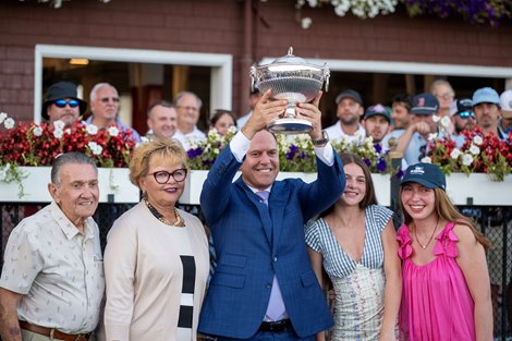 Trainer Chad Brown is surround by family members and holds the winner's trophy aloft after his charge My Gun's Loaded wins the 146th running of The Alabama Presented by Keeneland Sales GI at the Saratoga Race Course Saturday Aug.22, 2026 in Saratoga Springs, N.Y. Trainer Chad Brown is surround by family members and holds the winner's trophy aloft after his charge My Gun's Loaded wins the 146th running of The Alabama Presented by Keeneland Sales GI at the Saratoga Race Course Saturday Aug.22, 2026 in Saratoga Springs, N.Y.
