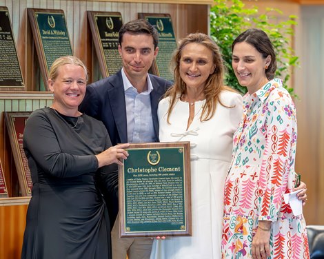 NMRHOF Director Cate Masterson presents the induction plaque of contemporary trainer, the late Christophe Clement to members of his family Miguel Clement, left Valerie Clement and Charlotte Clement Collins at the 2026 Hall of Fame Induction Ceremony held at the Fasig Tipton Sales Pavilion Friday Aug.7, 2026 in Saratoga Springs, N.Y. Photo by Skip Dickstein NMRHOF Director Cate Masterson presents the induction plaque of contemporary trainer, the late Christophe Clement to members of his family Miguel Clement, left Valerie Clement and Charlotte Clement Collins at the 2026 Hall of Fame Induction Ceremony held at the Fasig Tipton Sales Pavilion Friday Aug.7, 2026 in Saratoga Springs, N.Y. Photo by Skip Dickstein