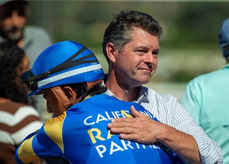 Trainer Leonard Powell, right, has a hug for jockey Adrian Escobedo, left, after Domain Expansion's victory in the Grade II, $200,000 Oak Leaf Stakes, Saturday, October 3, 2026 at Santa Anita Park, Arcadia CA. © BENOIT PHOTO Trainer Leonard Powell, right, has a hug for jockey Adrian Escobedo, left, after Domain Expansion's victory in the Grade II, $200,000 Oak Leaf Stakes, Saturday, October 3, 2026 at Santa Anita Park, Arcadia CA. © BENOIT PHOTO