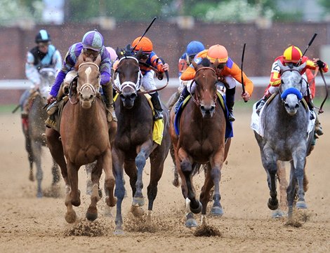 Princess Of Sylmar (L), Mike Smith up, run by Beholder and Unlimited Budget (orange hat) in the final stretch.