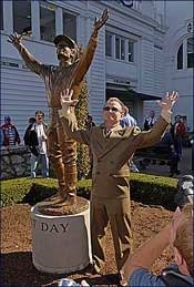 Hall of Fame Jockey Pat Day poses next to the Raymond Graf statue commemorating his 1992 Kentucky Derby win.