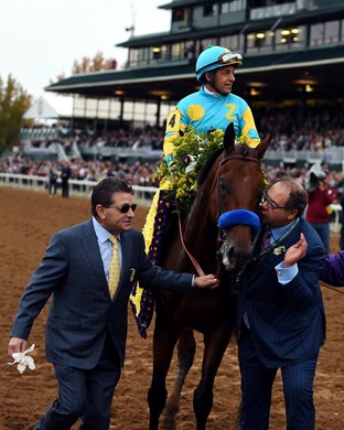 Owner Ahmed Zayat gives American Pharoah a kiss after his victory in the 2015 Breeders' Cup Classic