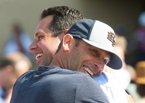 Bill Koch or Little Red Feather Racing, right, has a hug for trainer Philip D'Amato, left, after Midnight Storms victory in the Grade II, $200,000 Del Mar Mile