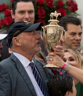 Jack Wolf of Starlight Racing kisses the trophy after Justify won the 144th running of the Kentucky Derby May 5, 2018 at Churchill Downs in Louisville, Kentucky