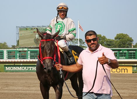 Trainer Jorge Navarro gives the thumbs up as he guides Find The Money and Jockey Jose Ferrer into the Winner&#39;s Circle after breaking his own single season Monmouth Park training record with his 66th victory on Thursday August 16, 2018 at Monmouth Park in Oceanport, N.J.  