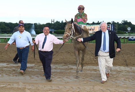 Lee Pokoik (right) leads Sippican Harbor into the winners circle at Saratoga Race Course