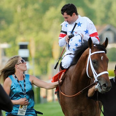 Jockey Kent Desormeaux speaks with assistant trainer Michele Nevin as Big Brown after winning  in the 133rd running of the Preakness Stakes at Pimlico Race Course in Baltimore, Maryland May 17, 2008.