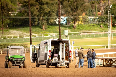 Santa Anita Park's track consultant Dennis Moore alongside CHRB and track officials this morning with the Orono Biomechanical Surface Tester, a device that mimics a horse's gallop