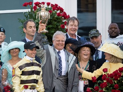 Trainer Bill Mott holds the winner's trophy aloft in celebration after the decision was made to take Maximum Security down and place Country House first in the 145th Kentucky Derby Saturday May 4, 2019 in Louisville, KY.  Photo by Skip Dickstein