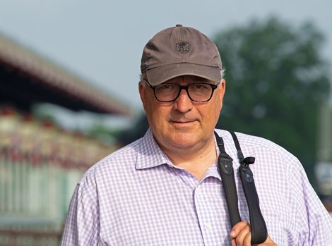 Trainer Christophe Clement with binoculars between sets on apron.  Mornings at Belmont Park June 6, 2019 in Elmont,  NY.  