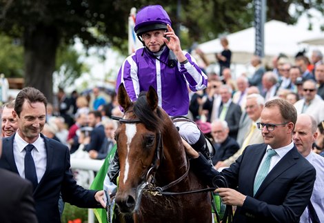 Japan (Ryan Moore) are led in by Paul Smith (left) and M V Magnier after the Juddmonte International<br><br />
York 21.8.19