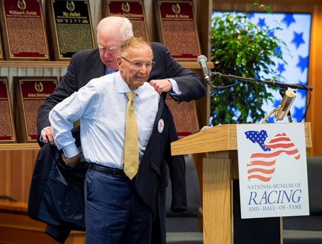 Dick Duchossois accepts his Hall of Fame jacket from Tom Durkin at the National Museum of Racing and Hall of Fame Inductions held at the Fasig Tipton sales arena Friday Aug. 2, 2019 in Saratoga Springs, N.Y.  