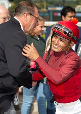 Jockey Abel Cedillo, right, celebrates with trainer Jeff Mullins, left, after River Boyne&#39;s victory in the G1, $400,000 Frank E. Kilroe Mile, Saturday, March 7, 2020 at Santa Anita Park, Arcadia CA.