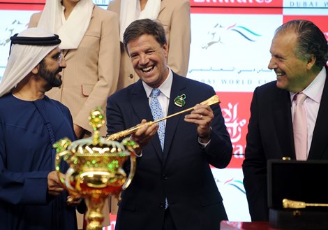 Race 9 Presentation - Dubai World Cup at Meydan, Sponsored By Emirates Airline Graham Motion accepts the trophy for the DUBAI WORLD CUP from Sheikh Majid Al Mualla, Senior Vice President Commercial Operations UAE on 30th of March, 2013.