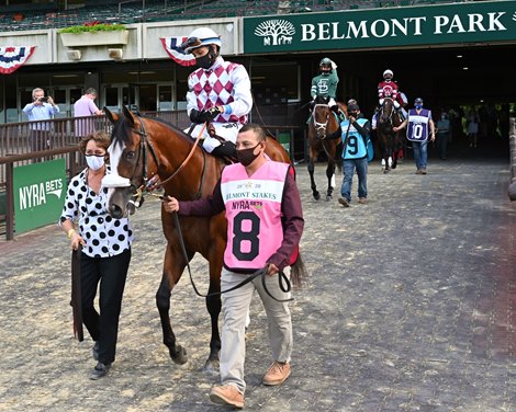 Tiz the Law goes to track with Robin Smullen, left, and  Tagg barn foreman Juan Barajas Saldana, right.