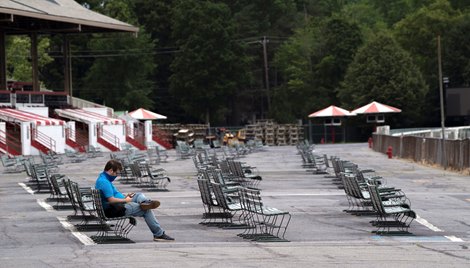 A media member is the only one using the benches on the apron in front of the grandstand on opening day at the Saratoga Race Course July 16, 2020 in Saratoga Springs, N.Y.