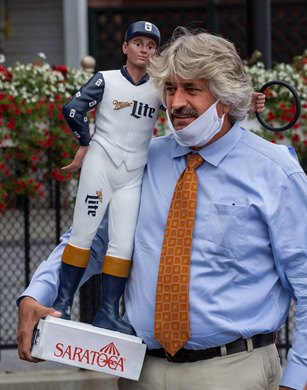 Trainer Steve Asmussen holds the winner’s award after Jackie’s Warrior with jockey Joel Rosario aboard put away the field to win the 115th running of The Saratoga Special presented by Miller Lite at the Saratoga Race Course Friday Aug. 7, 2020 in Saratoga Springs, N.Y.  