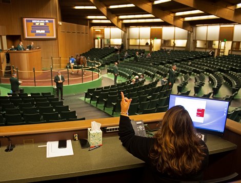 Michelle Labato works the internet bidding<br>
at Keeneland September sale yearlings in Lexington, KY on September 22, 2020.