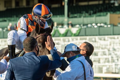 Alberto Figueiredo pats the head of Ivar as Joe Talamo celebrates with trainer Paulo Lobo after winning the Shadwell Turf Mile (G1) at Keeneland on October 3, 2020.