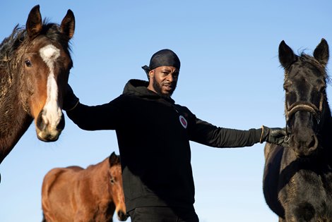 Freedom Tariq otherwise known as Fr33dom the founder of The Urban Equestrian Academy in the paddock with  his horses at Scraptoft Hill Farm near Leicester 15.12.20