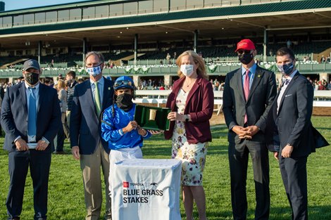 Brad Cox, Jimmy Bell, Luis Saez, presenters Susan Ellington, Clay Green, and Christian Towner after Essential Quality with Luis Saez up wins the Blue Grass Stakes (G2) at Keeneland on April 3, 2021.