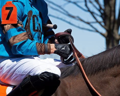 Corey Lanerie knotting his reins while on Bode by You in race 3.<br><br />
Scenes from opening day at Keeneland near Lexington, Ky., on April 2, 2021.