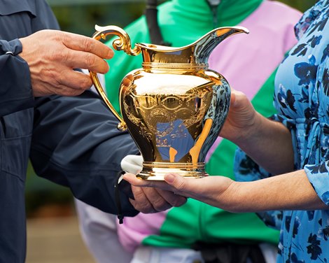 Special honor for 16 Stakes wins, the Gold Pitcher, held by (L-R) Garrett O’Rourke and Shannon Arvin. is presented to Juddmonte.  Juliet Foxtrot with Tyler Gaffalione wins the Coolmore Jenny Wiley (G1) at Keeneland near Lexington, Ky., on April 10, 2021. 