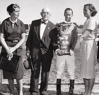 Alice and her father, Hal Price Headley, present a trophy at Keeneland, the track Headley helped found.
