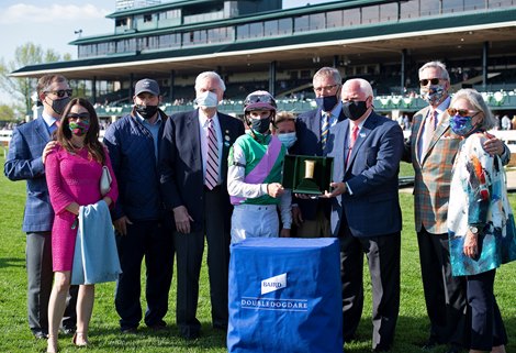 Presentation includes presenters Jim Allen, Steve Grossman, and Tom Kessinger as well as trainer Brad Cox (3rd left), John Chandler (4th left), jockey Florent Geroux, and Garrett O’Rourke (glasses, 4th from right). Bonny South with Florent Geroux wins the Baird Doubledogdare (G3) at Keeneland near Lexington, Ky., on April 16, 2021. . 