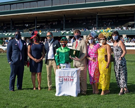 Presentation: assistant trainer Whit Beckman, third from left, presenter Rob Samuels, fifth from left. Raging Bull with Irad Ortiz Jr. wins the Makers Mark Mile (G1)<br>
at Keeneland near Lexington, Ky., on April 9, 2021. 
