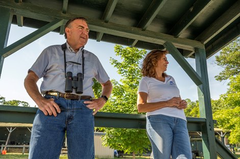 Trainer Jim Bond and wife Tina stand in the viewing stand on the backstretch of the main track to watch his charges gallop on the main trackon the main track at the Saratoga Race Course  Monday June 28, 2021 in Saratoga Springs, N.Y. . Photo by Skip Dickstein