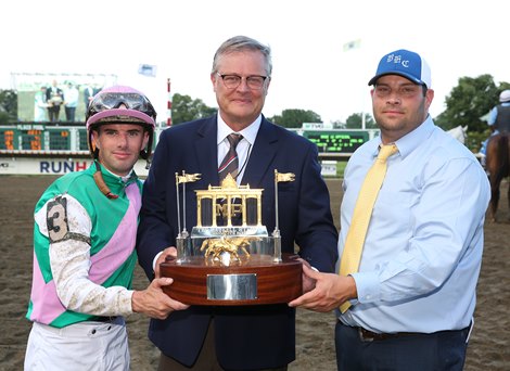 Jockey Florent Geroux, Garrett O&#39;Rourke of Juddmonte Farm and Trainer Brad Cox hoist the Haskell Trophy after Mandaloun won the $1,000,000 Grade I Haskell Stakes through disqualification of Hot Rod Charlie and Flavien Prat riding was disqualified from first and placed last at Monmouth Park Racetrack in Oceanport, NJ on Saturday July 17, 2021.  Photo By Bill Denver/EQUI-PHOTO
