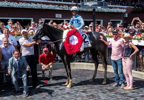 Maracuja with jockey Ricardo Santana Jr., stands in the winner’s circle with trainer Rob Atras and his wife Britteny Atras at his rear quarter after winning  the 105th running of The Coaching Club American Oaks at The Saratoga Race Course Saturday July 24, 2021 in Saratoga Springs, N.Y.