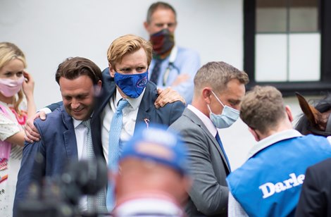 Trainer Ed Walker (R) hugs bloodstock agent Ed Sackville after Starman's  win in the July Cup<br>
Newmarket 10.7.21