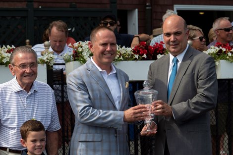 Trainer Chad Brown receives one of his many winners trophies from VP of Racing Martin Panza at the Saratoga Race Course in Saratoga Springs, N.Y. 