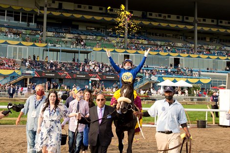 Jockey Irad Ortiz Jr.throws the flowers after guiding Safe Conduct to victory.Safe Conduct  leading into winners circle by breeder Mitch Kursner.