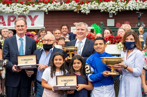 Jimmy Bell, Dan Pride, Gov. Kathy Hochul and winning connections in the winner’s circle after Essential Quality with Luis Saez win the Runhappy Travers Stakes (G1) at Saratoga Race Course in Saratoga Springs, N.Y., on Aug. 28, 2021. 
