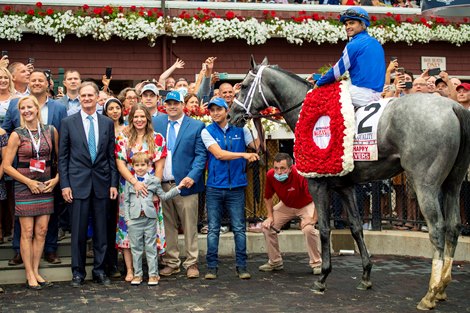 Jimmy Bell, Livia Frazar, Brad H. Cox and winning connections in the winner’s circle after Essential Quality with Luis Saez win the Runhappy Travers Stakes (G1) at Saratoga Race Course in Saratoga Springs, N.Y., on Aug. 28, 2021. 