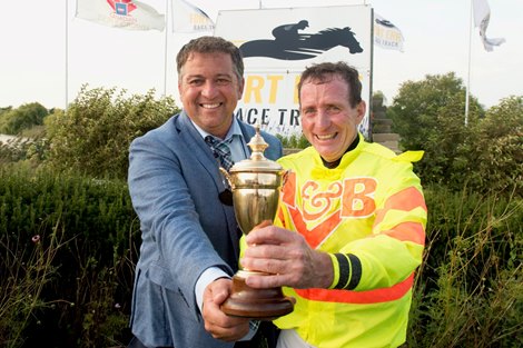 Trainer Kevin Attard(L) and jockey Gary Boulanger (R) hold the POW trophy after Haddassah  capture the $400,000 dollar 2nd.leg of the Canadian triple crown.