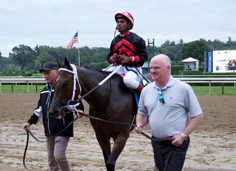 Mark Levenson leads Echo Zulu and jockey Ricardo Santana Jr. to the winner’s circle after winning the 130th running of the Spinaway at the Saratoga Race Course Sunday Sep, 5, 2021 in Saratoga Springs, N.Y.  Photo  by Skip Dickstein