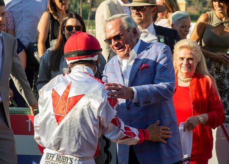 Peter Fluor of Speedway Stables, right, celebrates with jockey Mike Smith, left, after Corniche&#39;s win in the G1, $300,000 American Pharoah Stakes, Friday, October 1, 2021 at Santa Anita Park, Arcadia CA.