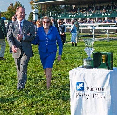 Clifford Barry, PIn Oak manager, escorts Josephine Abercrombie to the trophy presentation.<br>
Overheard with Eurico Da Silva up wins the Pin Oak Valley View (gr. IIIT) for owner Mrs. Josephine Abercrombie, owner of Pin Oak Farm on Oct. 18, 2013, at Keeneland in Lexington, Ky.<br>
PinOakValleyViewsRAW image328<br>
Photo by Anne M. Eberhardt<br>
