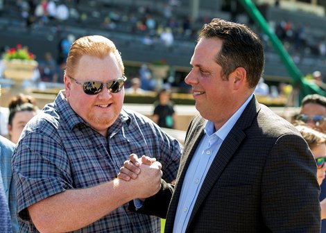 Co-owner Michael Nentwig, left, celebrates with trainer Philip D&#39;Amato, right, after Going Global&#39;s victory in the G2, $200,000 Royal Heroine Stakes, Saturday, April 9, 2022 at Santa Anita Park, Arcadia CA.