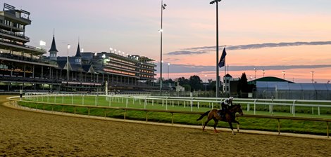 A horse trains as the sun rises on track during training hours at Churchill Downs Race Track Thursday May 5, 2022 in Louisville, KY.  