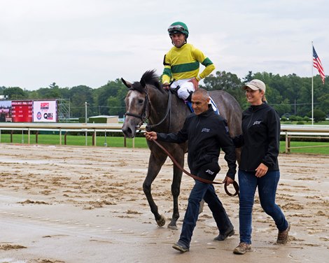 Horse named for assistant trainer Melanie Giddings, on right. Maple Leaf Mel with Joel Rosario wins The Seeking the Ante.<br>
Travers week at Saratoga Race Course on Aug. 26, 2022.