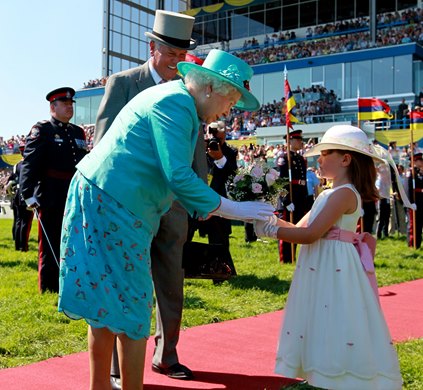 Queen Elizabeth II is presented with a bouquet of flowers at Woodbine Racetrack in 2010