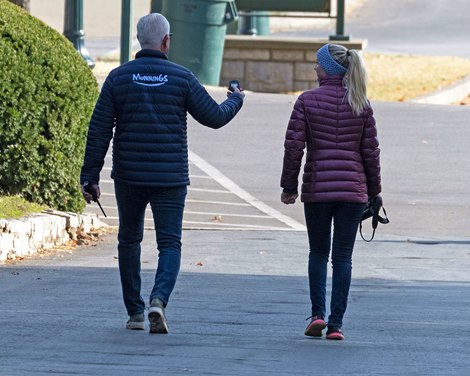 (L-R): After watching their morning turf works, trainer Todd Pletcher and assistant trainer Amelia Green walk back to their barn. <br><br />
Training at Keeneland on Oct. 21, 2022.