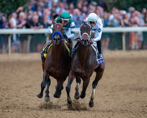 Flightline (outside, green cap), with Flavien Prat aboard, makes his move around the final turn to win the 2022 Breeders' Cup Classic at Keeneland.