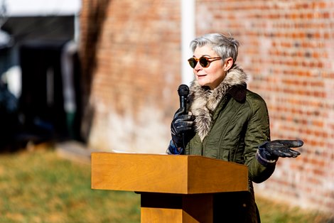 Equine artist Jaime Corum speaks at the unveiling of the Secretariat mural in Paris, KY, on Nov. 19, 2022.